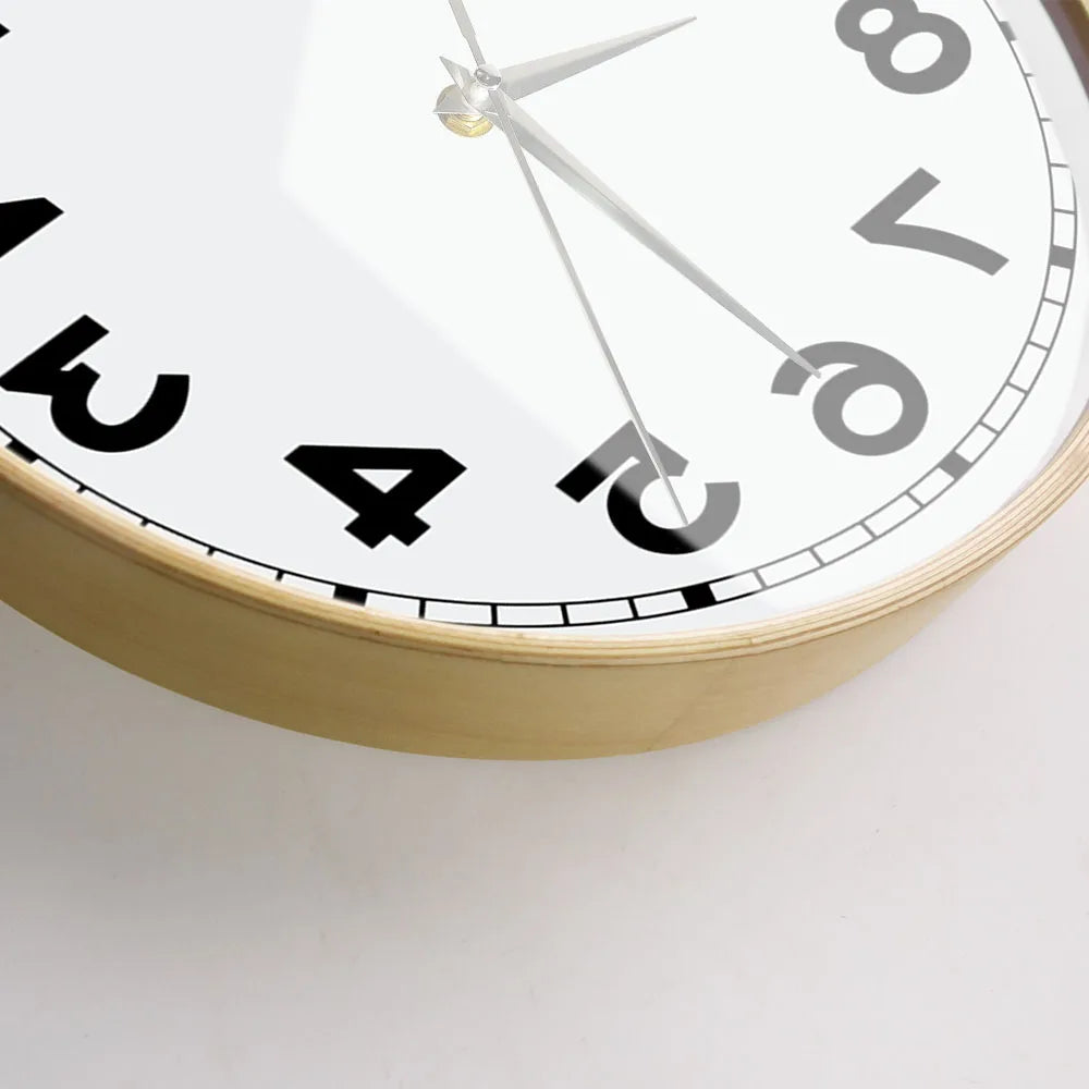 Close-up of the wooden frame and lower reversed numerals on the wall clock