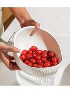 Rice Rinsing Strainer Bowl — White bowl tilted to drain cherry tomatoes