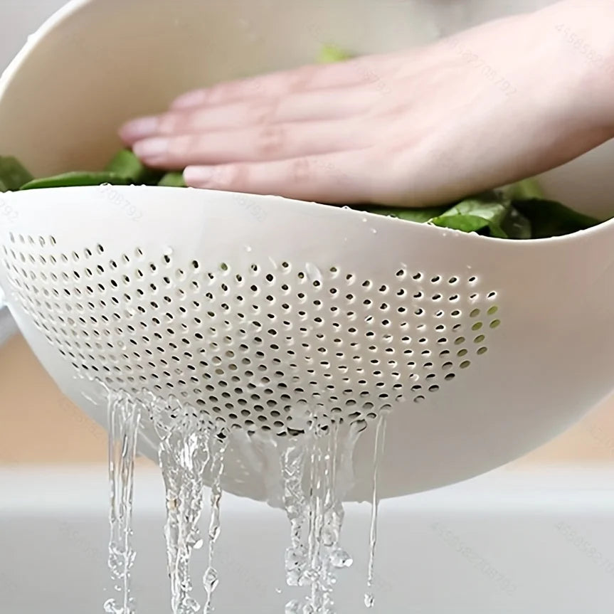Rice Rinsing Strainer Bowl — Close-up of water draining through perforations with leafy greens inside
