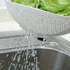 Rice Rinsing Strainer Bowl — Close-up of lettuce rinsing and water flowing through side perforations