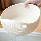 Rice Rinsing Strainer Bowl — Close-up of rice retained while water pours through side holes