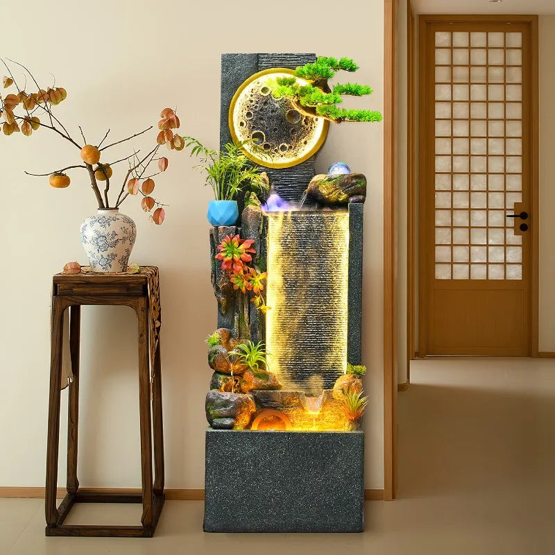 Rockery Water Fountain in a hallway beside a tall vase stand and a wooden door.