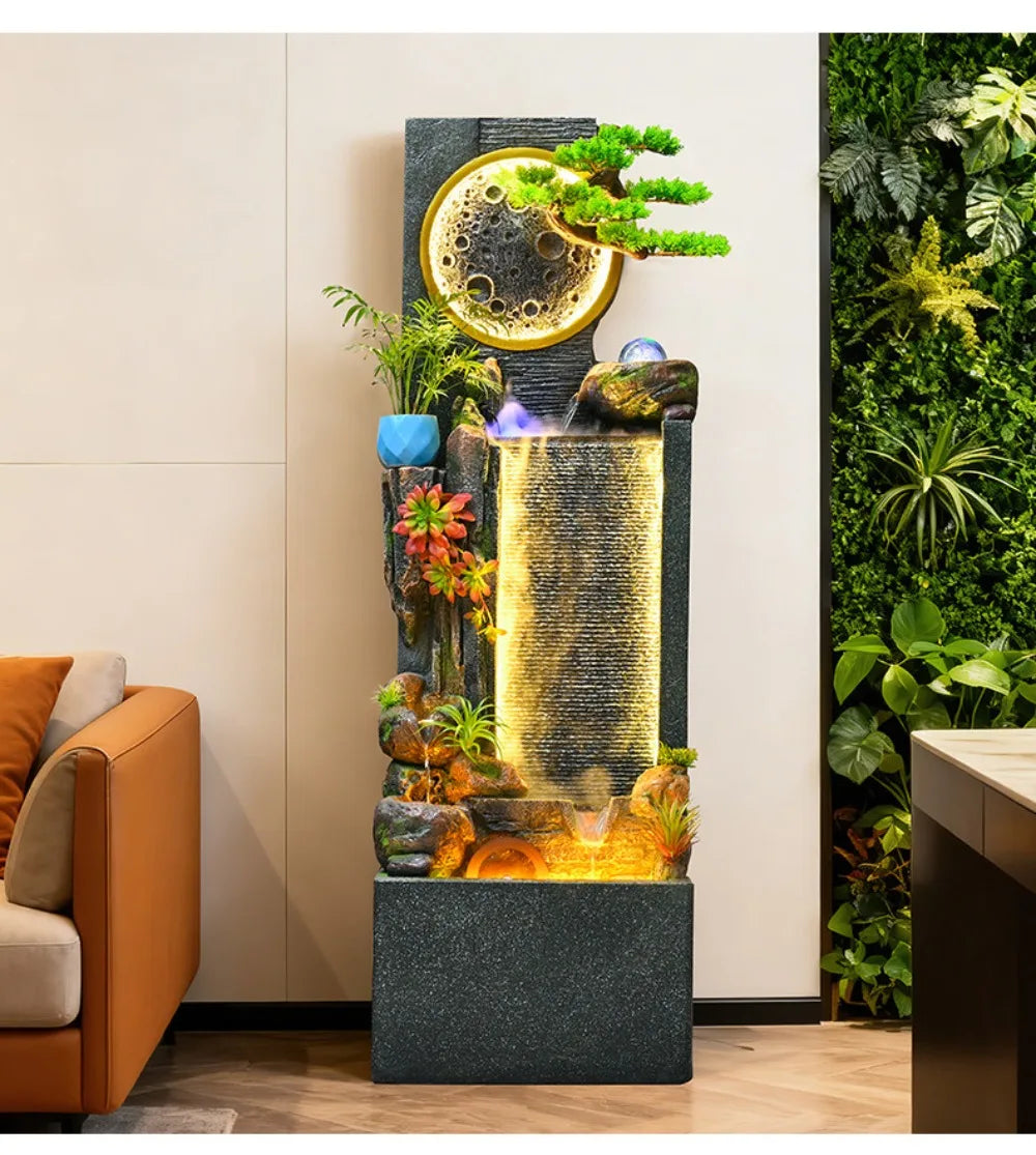 Rockery Water Fountain full-height view beside an indoor plant wall and orange seating.