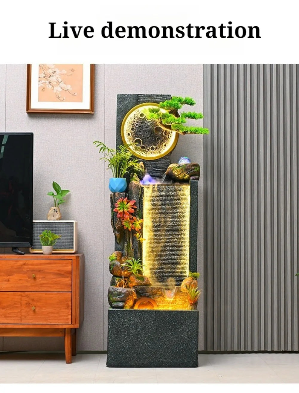 Rockery Water Fountain demonstration photo beside a TV cabinet and gray vertical wall panels.