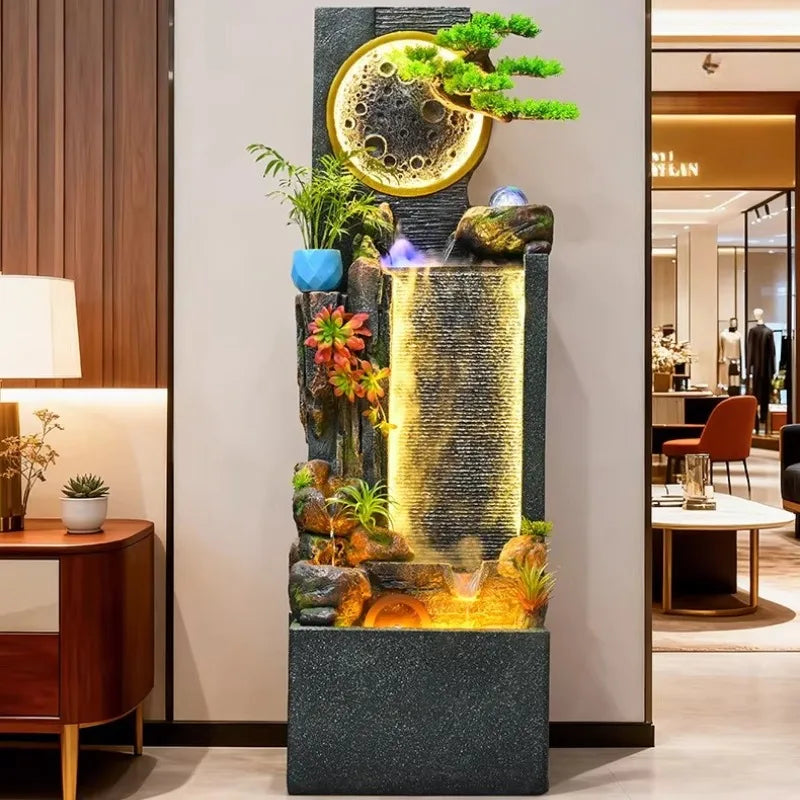 Rockery Water Fountain displayed against a showroom wall beside a wooden cabinet and lamp.