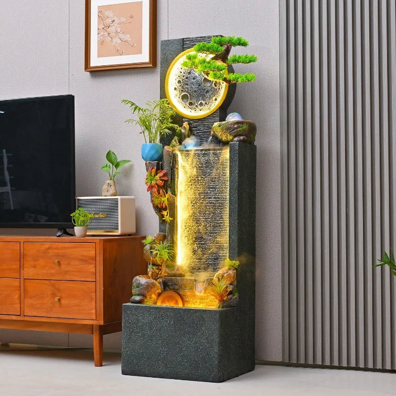 Rockery Water Fountain viewed from the side beside a TV cabinet, showing its deep rectangular base.