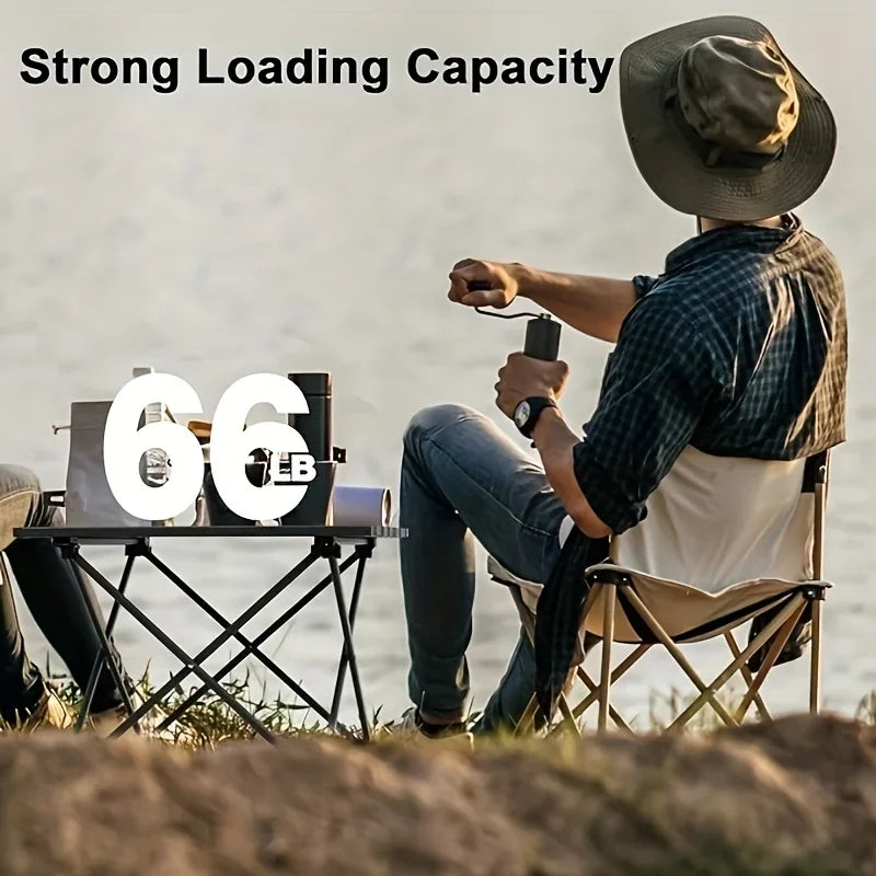 Roll-Up Camping Table beside a lakeside camper, with a supplier graphic stating a 66 lb capacity.