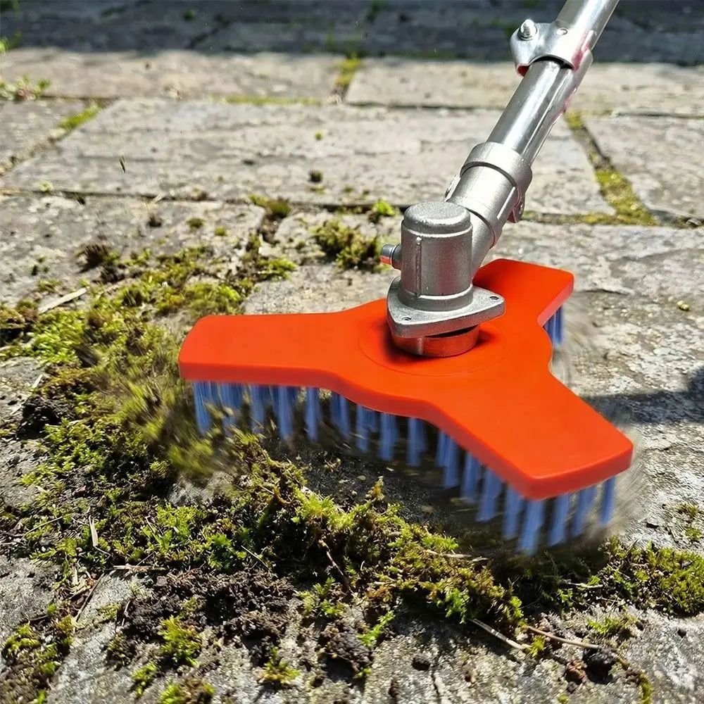 Rotary Surface Cleaning Brush lifting thick moss and debris from joints between outdoor pavers