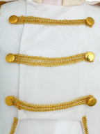 Royal Prince Costume white jacket close-up showing three rows of decorative gold braid and round buttons.