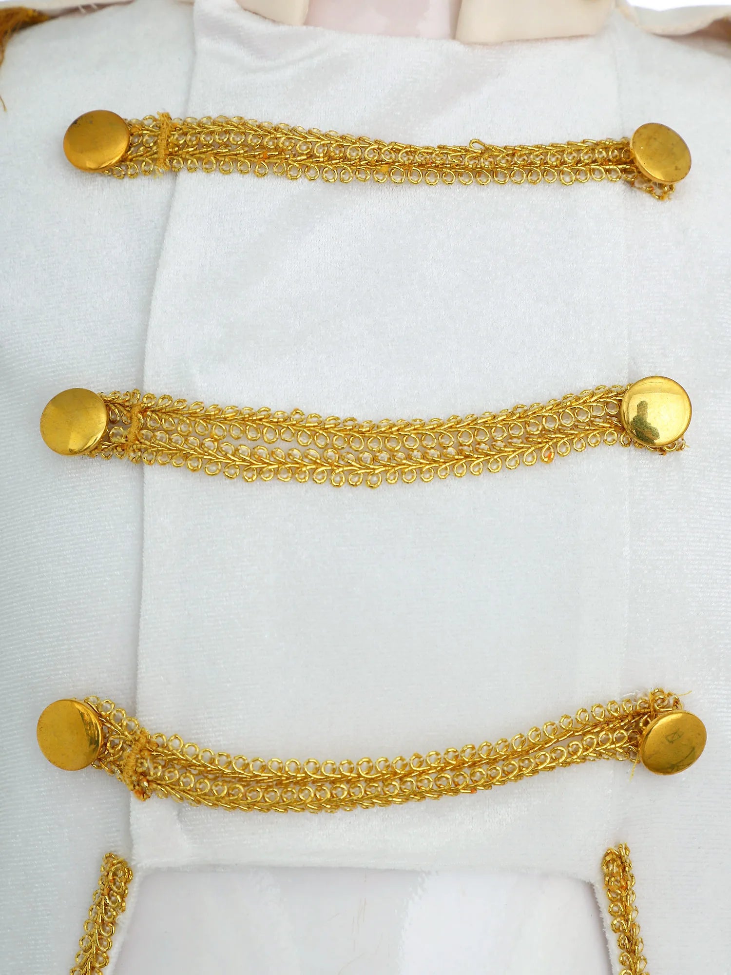 Royal Prince Costume white jacket close-up showing three rows of decorative gold braid and round buttons.