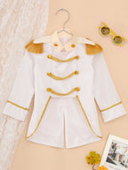 Royal Prince Costume white jacket on a hanger beside lace and yellow sunglasses on a peach background.