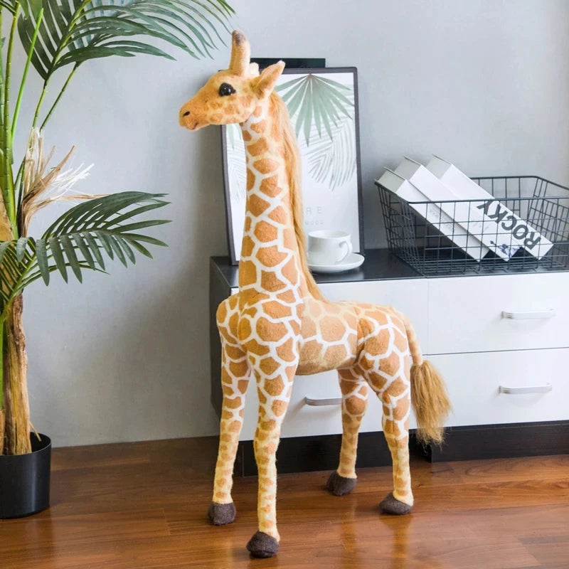 Safari Giraffe Stuffed Animal standing beside a potted palm and white cabinet.