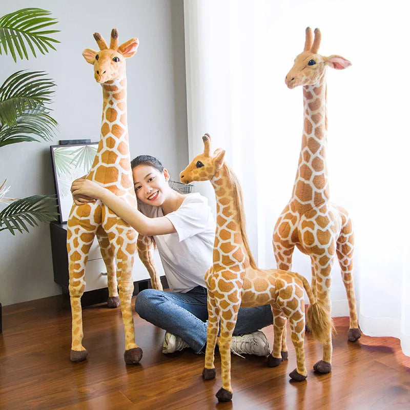 Safari Giraffe Stuffed Animal three sizes shown with a woman hugging a tall giraffe.