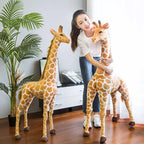 Safari Giraffe Stuffed Animal a woman standing and hugging one of two giraffes.