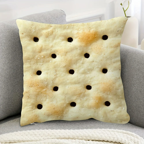 Saltine Cracker Pillow Cover styled on a gray sofa with the cracker print facing forward