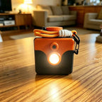 Saltwater Emergency Light on a wooden table with its orange cord wrapped around the cap and clip at the side