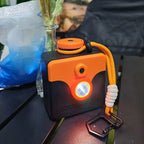 Saltwater Emergency Light angled on a dark table, with the orange cord and black clip extended beside it
