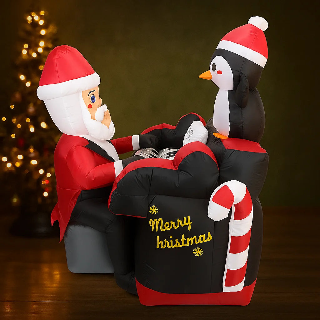 Santa Penguin Piano Inflatable indoor side view with Merry Christmas lettering and a candy-cane accent.