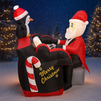 Santa Penguin Piano Inflatable displayed against snowy trees at night, with Santa seated at the keyboard.