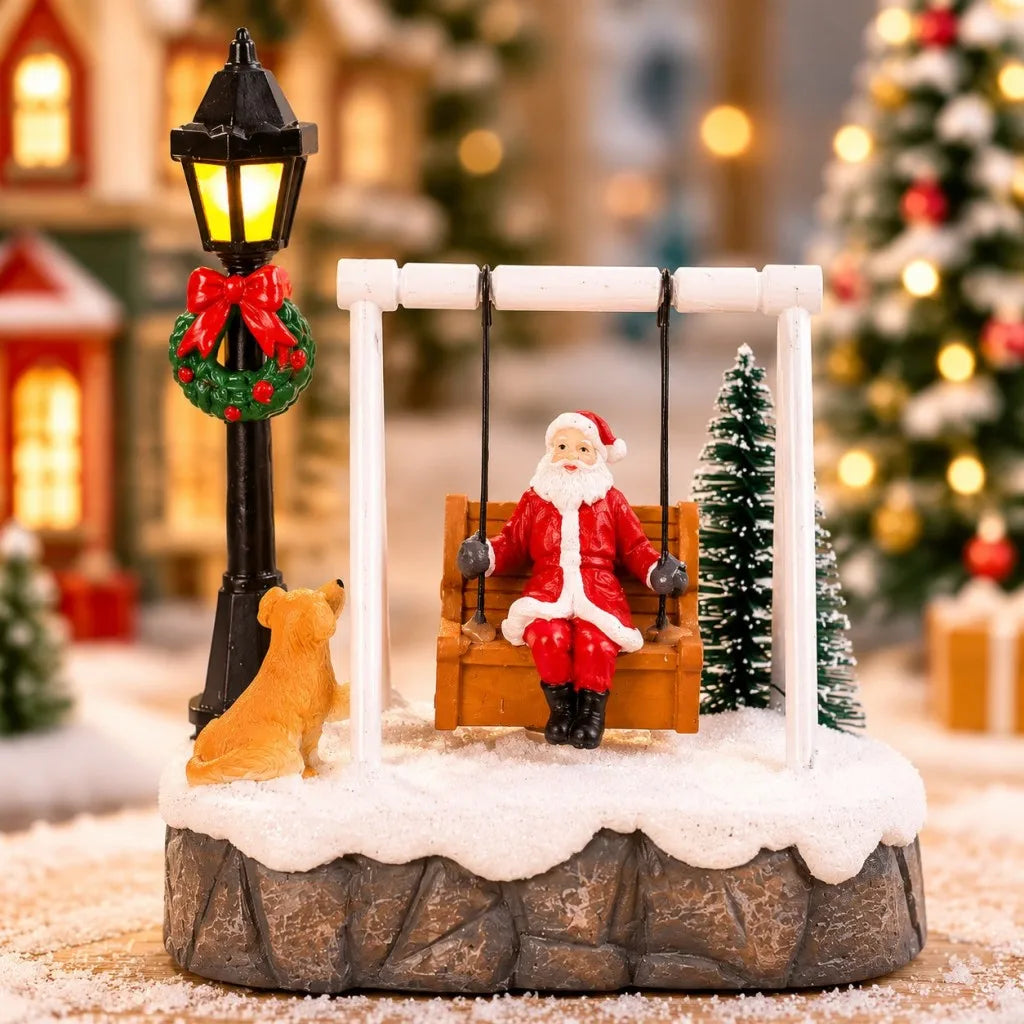 Front close-up of Santa Swing Christmas Scene with dog and warm LED lamppost against village lights