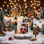 Santa Swing Christmas Scene among snowy village houses, gifts, a sled and warm string lights