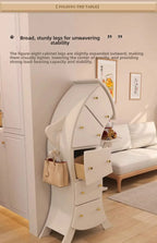 Sassy Pants Drawer Cabinet: White cabinet beside a sofa with the middle drawer open and a handbag on its hook.