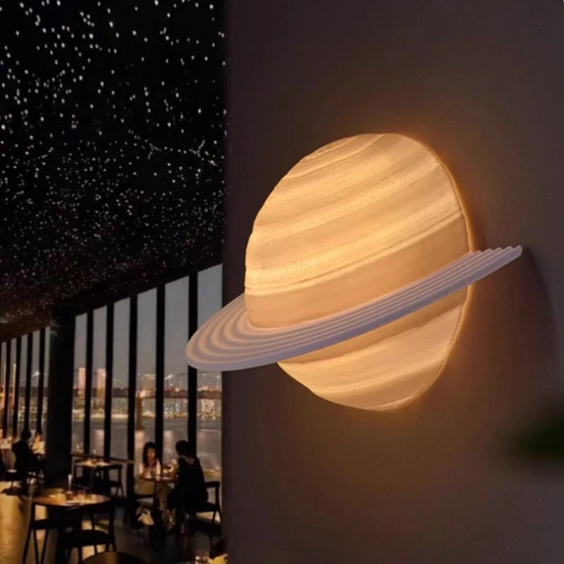 Saturn Hemisphere Wall Lamp glowing with warm light on a dark feature wall