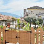 Self-Locking Gate Latch units installed across a large wooden outdoor fence gate