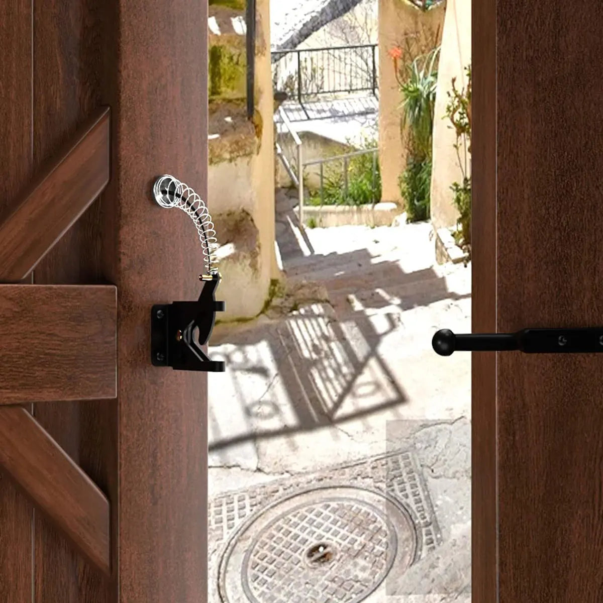 Self-Locking Gate Latch mounted on an open wooden outdoor gate with cable pull accessible