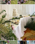 Serpentine Event Display Table white-draped curved display with a tiered cake, desserts, glassware and greenery.