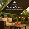 HighPeak ShadeGuard in dark fabric shading a cozy outdoor deck with wicker furniture and drinks on a sunny evening
