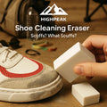HighPeak Shoe Cleaning Eraser in white being used to clean scuffed sneaker with beige and red details on wooden surface