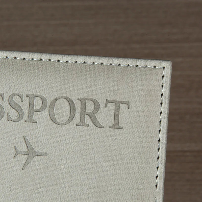 Signature Leather Passport Cover close-up of Gray PU leather texture, passport lettering and edge stitching.