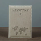 Signature Leather Passport Cover in Gray standing on a wooden tabletop with its complete front visible.