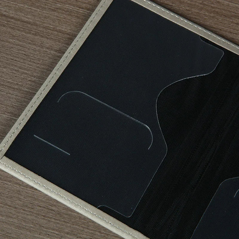 Signature Leather Passport Cover close-up of dark interior card slots and a curved document-pocket opening.