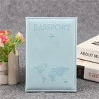 Signature Leather Passport Cover in Light Blue, shown upright beside flowers with its pale aqua finish.
