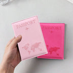 Signature Leather Passport Cover in Light Pink held in one hand, with a Rose Red cover resting behind it.