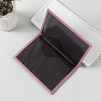 Signature Leather Passport Cover opened to show the dark interior document pockets and pink stitched border.
