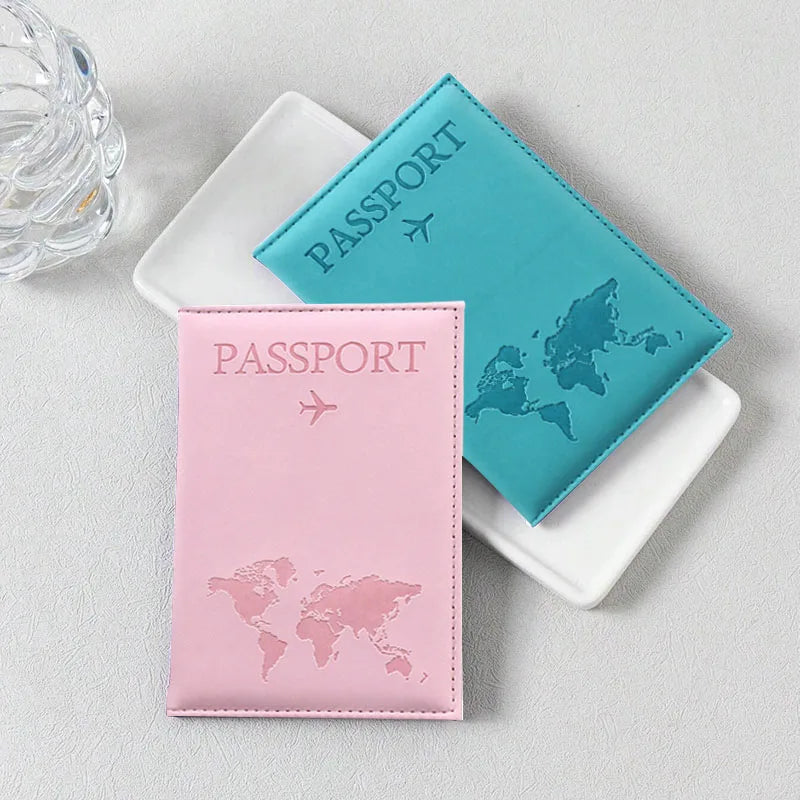 Signature Leather Passport Cover in Light Pink and turquoise Blue, arranged beside a white tray.