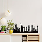 Skyline Wall Decal displayed above a wood console with plants, a clock and modern pendant lights