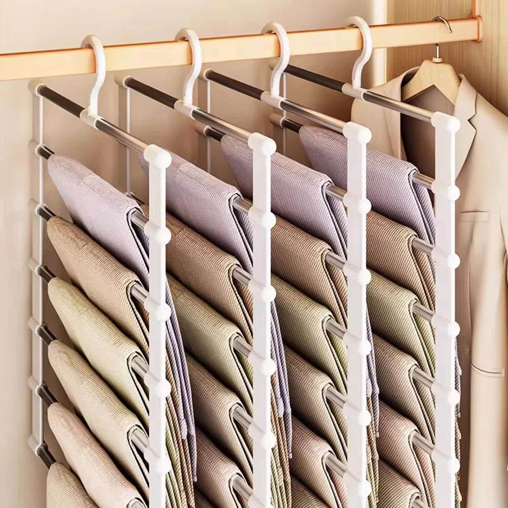 Space Saving Pants Hanger arranged in a row of four racks holding neutral-colored trousers beside a white jacket.