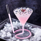 Spiral Straw Cocktail Glass displaying a pale pink drink with petals and a rosebud garnish
