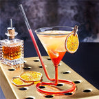Spiral Straw Cocktail Glass showing an orange garnish and a red drink in the looped straw