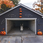 Spooky Girl Garage Banner on a dark house decorated with bat outlines and orange pumpkins