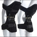 Two Spring Knee Support Braces on mannequin knees, showing black fabric panels, fastened straps and metal springs.
