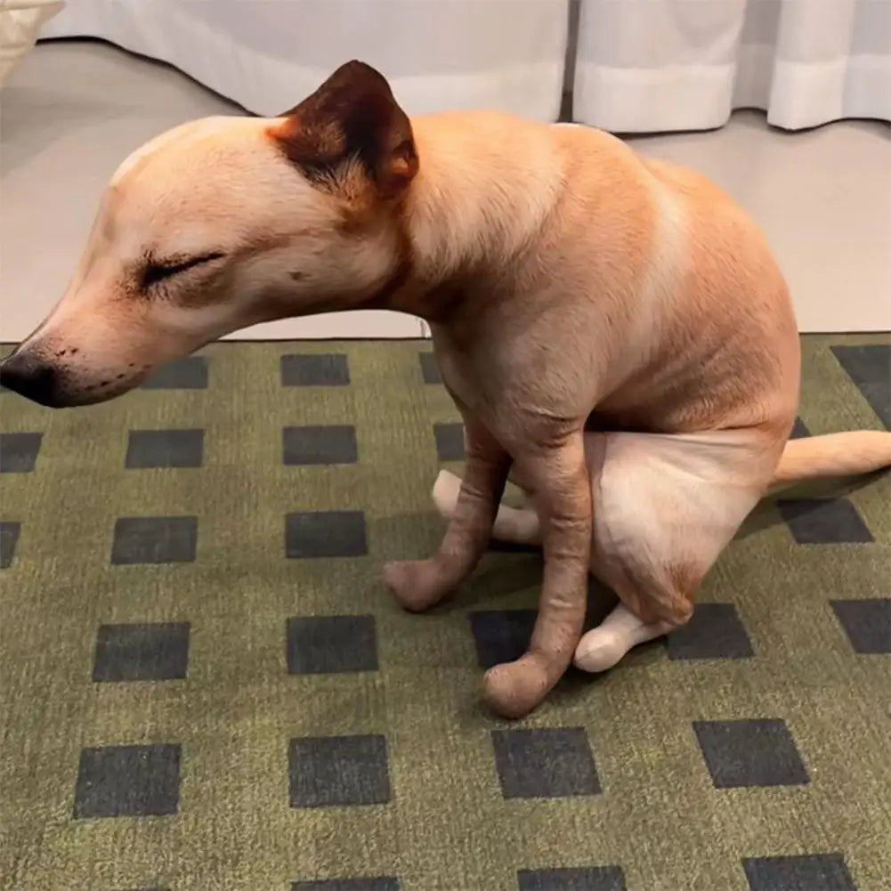 Squatting Dog Plush Toy tan dog in a squatting pose on a green rug with dark square patterns.