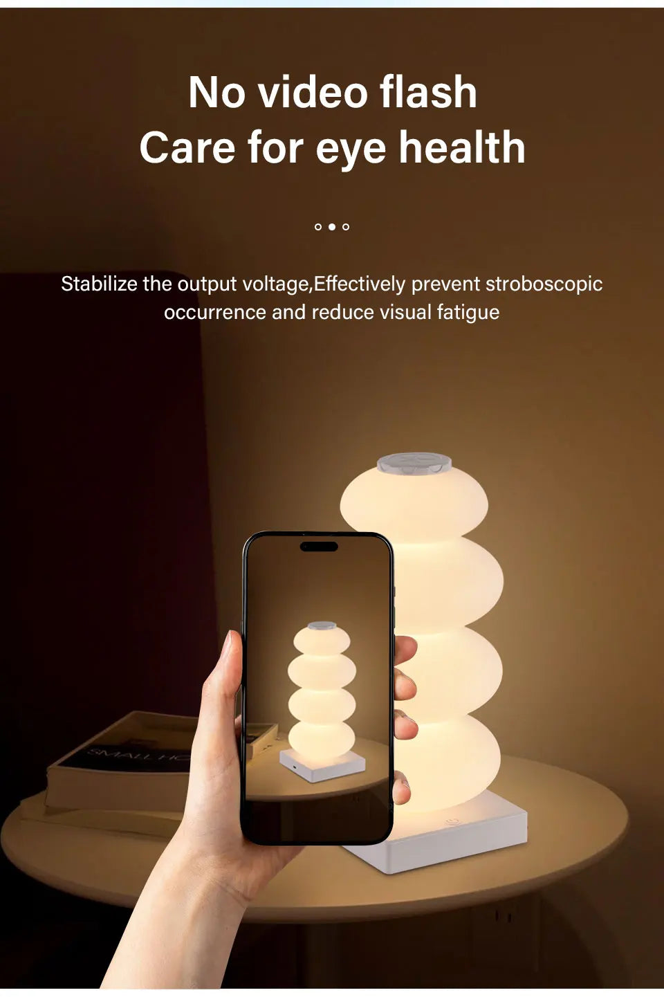 Stacked Pebble RGB Lamp glowing warm white behind a phone showing the same lamp.
