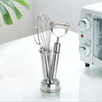 Stainless Toothbrush Holder used as a freestanding organizer for a whisk and vegetable peeler