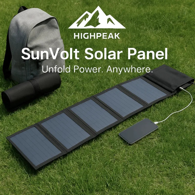 HighPeak SunVolt Solar Panel unfolded on grass charging a phone with a backpack and thermos nearby outdoors