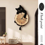 Swinging Cat Wall Clock black cat variant mounted beside décor with a round wooden clock face